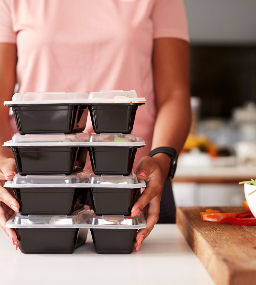 Close Up Of Woman Preparing Batch Of Healthy Meals At Home In Kitchen